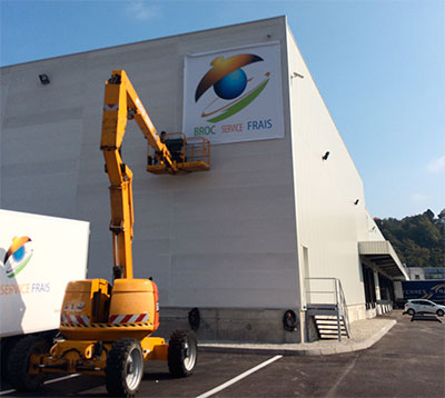 Travaux en hauteur à la nacelle VL pour la pose d’enseigne sur entrepôt à Saint-Remimont
